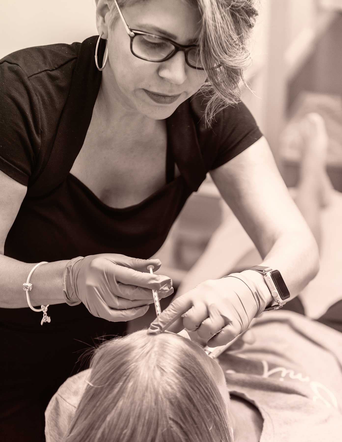 Esthetician applying Botox